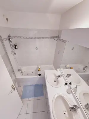 a bathroom with two sinks and a bathtub and a tub at T3 Panoramique Centre Aix en Provence in Aix-en-Provence