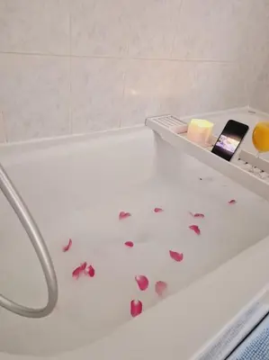 a bath tub with hearts on the floor in a bathroom at T3 Panoramique Centre Aix en Provence in Aix-en-Provence