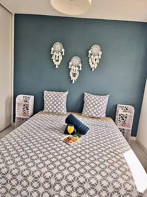 a bedroom with a bed with skulls on the wall at T3 Panoramique Centre Aix en Provence in Aix-en-Provence