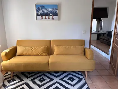 a brown couch in a living room with a mirror at Casa Lub in Apt
