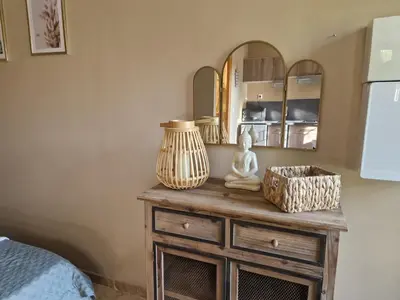 a bedroom with a table with a vase on it at le mazet de LOÏS in Carpentras