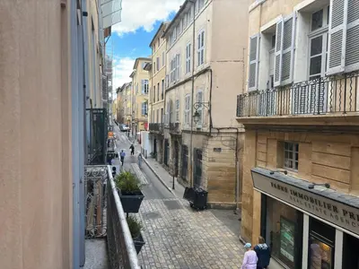 a city street with people walking down the street at Le Loft du Matheron in Aix-en-Provence