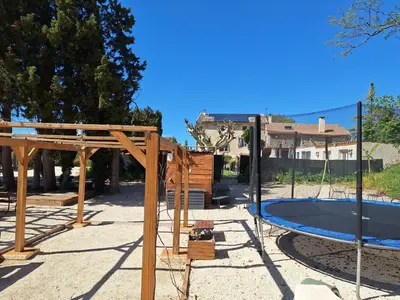 a playground with a trampoline at Valentins cottage Moulin de Tartay Avignon in Avignon