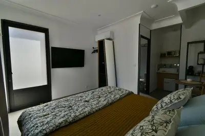 a bedroom with a bed and a flat screen tv at Une nuit en Luberon et SPA in Puyvert
