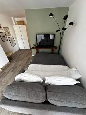 a bed with two pillows on it in a room at Charmant T2 atypique proche du centre-ville in Miramas