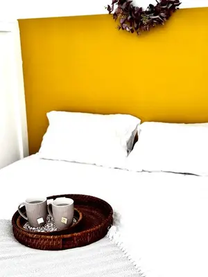 a tray with two coffee cups on a bed at Charmant T2 atypique proche du centre-ville in Miramas