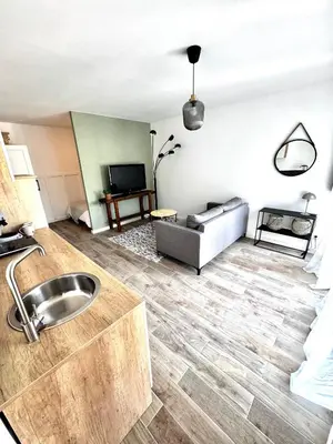 a living room with a sink and a couch at Charmant T2 atypique proche du centre-ville in Miramas