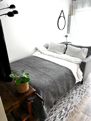 a bedroom with a bed and a plant on a table at Charmant T2 atypique proche du centre-ville in Miramas