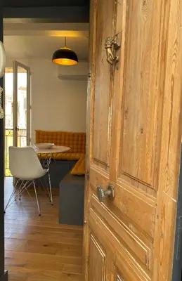 an open door to a room with a table and a chair at Studio centre historique Aix en Provence in Aix-en-Provence