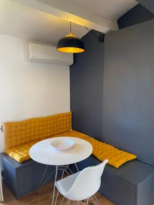 a room with a table and chairs and a couch at Studio centre historique Aix en Provence in Aix-en-Provence