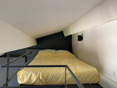a small bedroom with a bed in a attic at Studio centre historique Aix en Provence in Aix-en-Provence