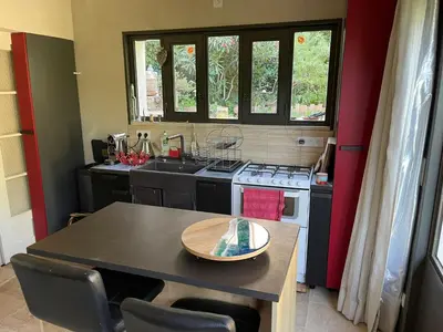 a small kitchen with a table and a stove at Charmante Maison au cœur du village in Rustrel