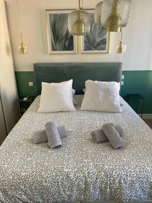 two towels on a bed with two pillows on it at Appartement climatisé 2 chambres Centre historique in Aix-en-Provence