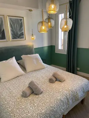 a bedroom with a bed with two towels on it at Appartement climatisé 2 chambres Centre historique in Aix-en-Provence