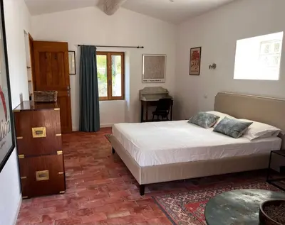 a bedroom with a bed and a table in it at Bergerie in Montjustin