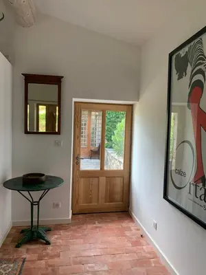 a room with a table and a wooden door at Bergerie in Montjustin