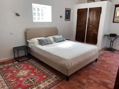 a bed with two pillows on it in a bedroom at Bergerie in Montjustin