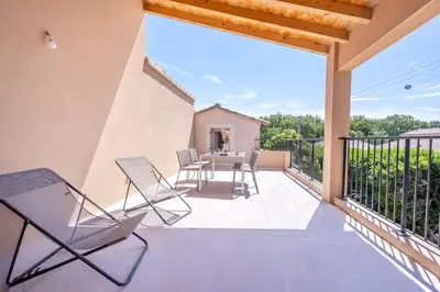 a patio with chairs and a table on a balcony at Tropiques en Provence in Morières-lès-Avignon