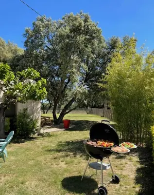 a grill in a yard with some food on it at Domaine Camp Fourca in Mirabeau