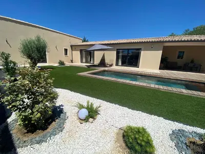 a backyard with a swimming pool and a house at La bastide de marie in Robion en Luberon
