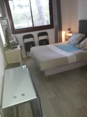 a small bedroom with a bed and a window at Studio 107 in Aix-en-Provence
