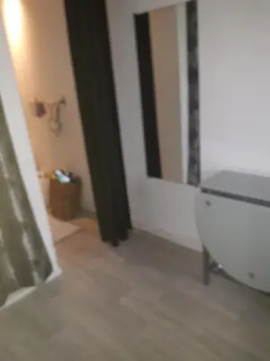 a bathroom with a white toilet and a mirror at Studio 107 in Aix-en-Provence