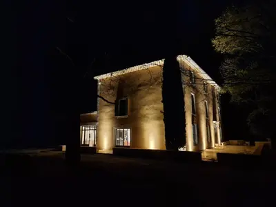 an old building at night with lights on it at Bastide des 7 Sœurs in Roussillon