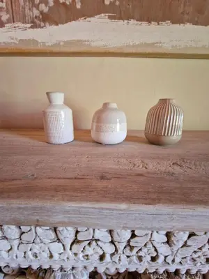 three vases are sitting on a wooden shelf at Bastide des 7 Sœurs in Roussillon