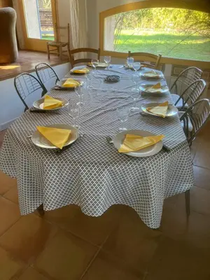 a table with glasses and plates and napkins on it at La maison Danna in Lauris