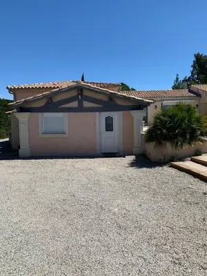 a house with a gravel driveway in front of it at Studio le soleil couchant in Saint-Saturnin-lès-Avignon