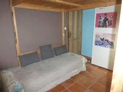 a bedroom with a bed in a room with a door at Mas Aubert in Eyragues