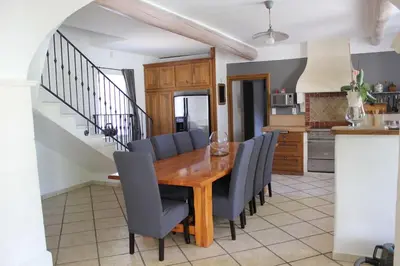 a dining room with a wooden table and chairs at Mas Aubert in Eyragues