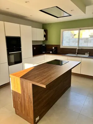 a kitchen with a wooden island in the middle at Villa Zen in Entraigues-sur-la-Sorgue