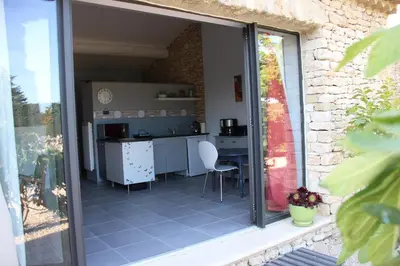 a view of a kitchen through a sliding glass door at La cigale bleue in Gordes