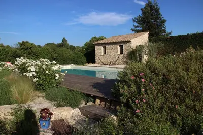 a house with a swimming pool in a garden at La cigale bleue in Gordes