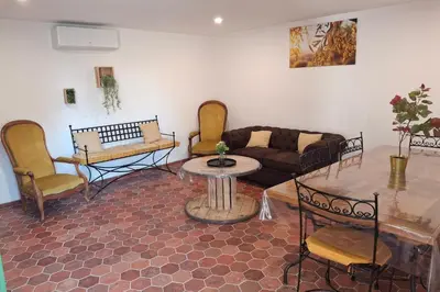 a living room with a couch and a table and chairs at La maison d'Antoine à Robion in Robion en Luberon