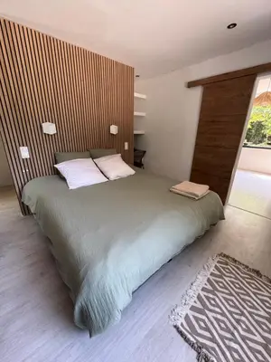 a bedroom with a large bed in a room at La maison vauclusienne in Carpentras