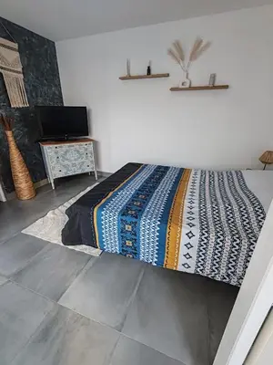 a bedroom with a bed with a colorful blanket on it at Chambre d'hôtes privée et indépendante avec piscine in Salon-de-Provence