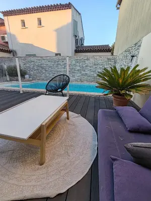 a patio with a table and a bench on a deck at Chambre d'hôtes privée et indépendante avec piscine in Salon-de-Provence