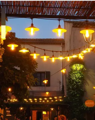a string of lights hanging from a building at Maison Paulette in Eygalières
