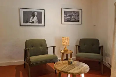 a room with two chairs and a table and a lamp at Maison Paulette in Eygalières