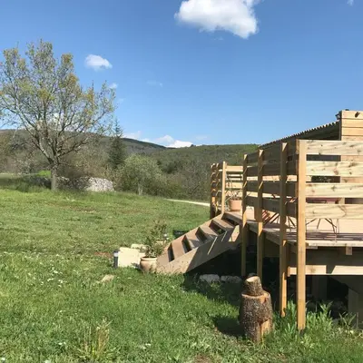 a wooden bridge in the middle of a field at Le Mas de Loume in Sault-de-Vaucluse