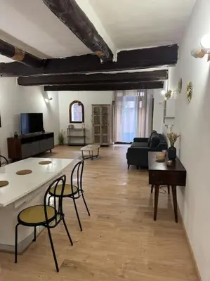 a large living room with a table and chairs at Appartement T2 Cosy centre-ville in Pernes-les-Fontaines