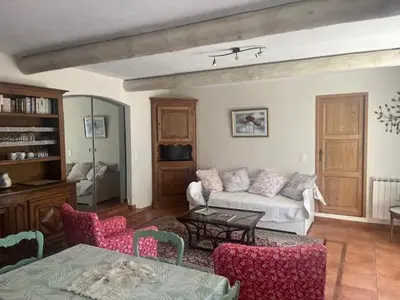 a living room with a couch and a table at La Louvière Plaine d'Eygalières in Orgon