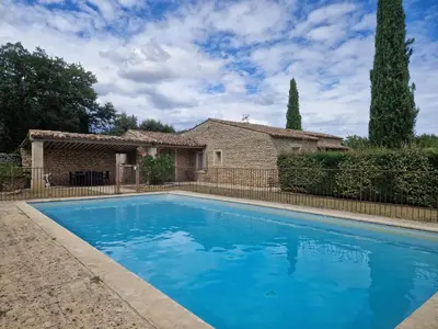 a swimming pool in front of a house at Villa Trempadou in Gordes