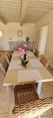 a dining room table with flowers on top of it at Villa Trempadou in Gordes