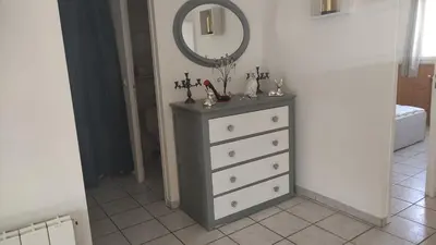 a dresser with a mirror on top of it at L'Appart in Cheval-Blanc