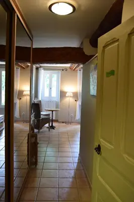 a hallway with a living room with a table at La Chambre des Amis au Moulin des GYPSES, Ventoux in Mormoiron