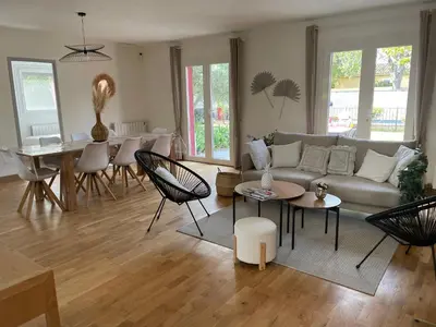 a living room with a couch and a table at A l'ombre des oliviers in LʼIsle-sur-la-Sorgue