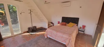 a bedroom with a bed and a staircase at Mazet in Rognes